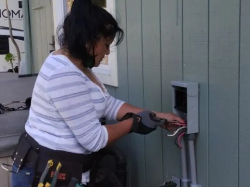 Licensed electrician wiring an exterior subpanel in Robinson